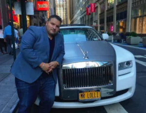Successful man leans on his expensive car
