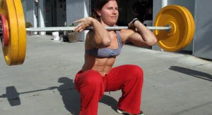 Woman performs front loaded squats