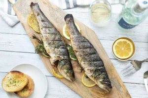 Two grilled fish with lemon