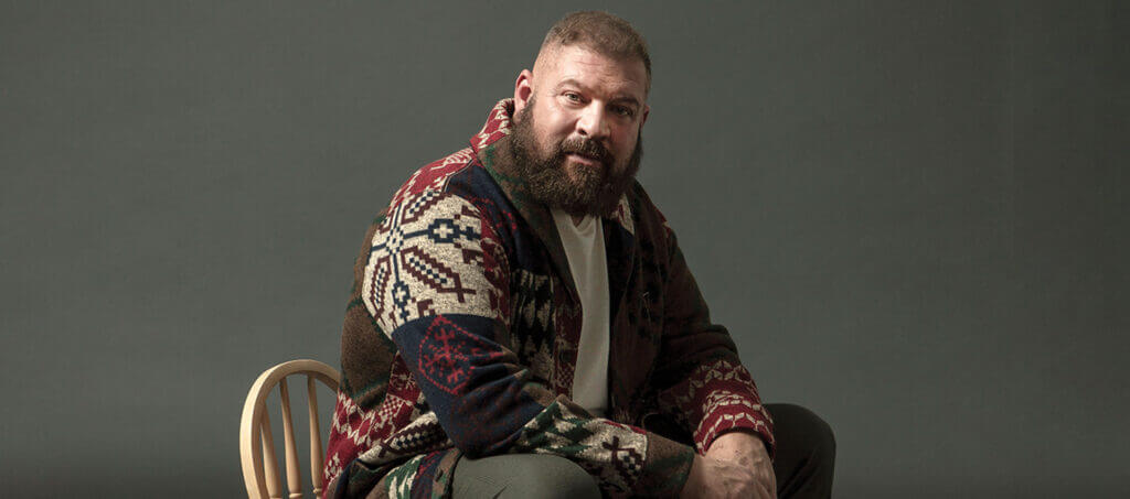 Brad William Henke sitting in a chair