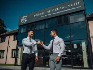 Two dentists outside their clinic