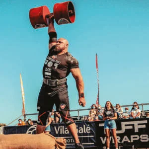 Travis Ortmayer doing huge dumbbell shoulder press