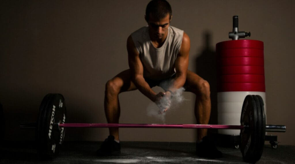 man prepares to do a deadlift