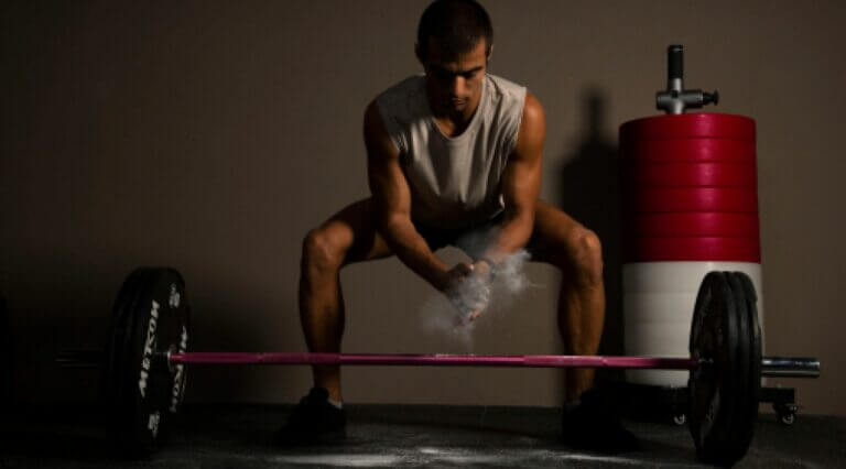 man prepares to do a deadlift