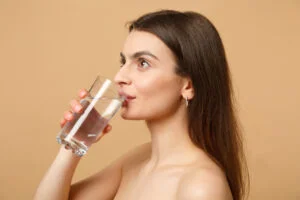 Woman hydrating with water