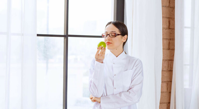 Woman eating an apple for good skin