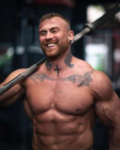 Bodybuilder holding barbell in the gym