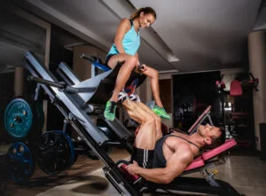 Man and woman lifting weights