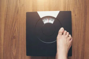 Woman checks weight on scales