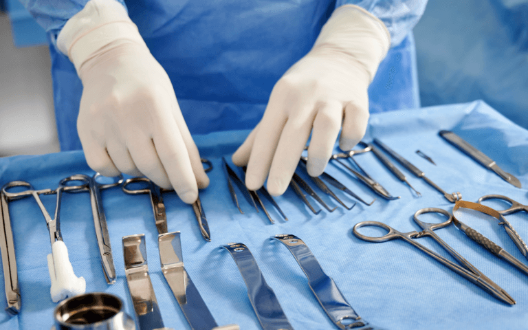 Cosmetic surgeon preparing scalpels